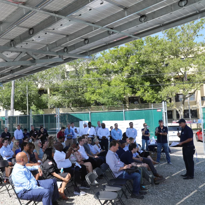 Man speaking to seated group of people about developing clean energy storage sites